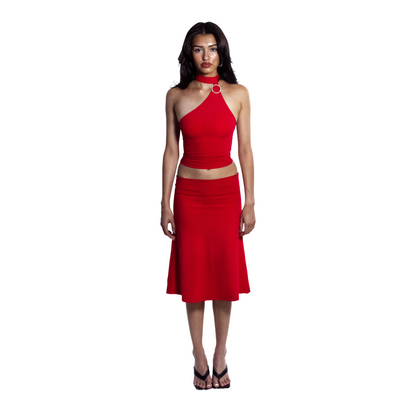 Full body view of barbados red asymetrical top with circle brooch and midi knee-length skirt